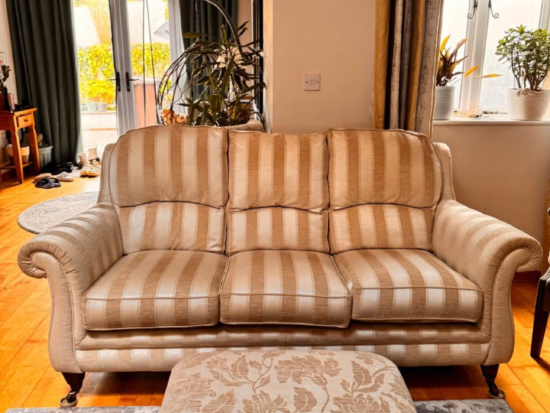 Parker Knoll beige three seater and footstool