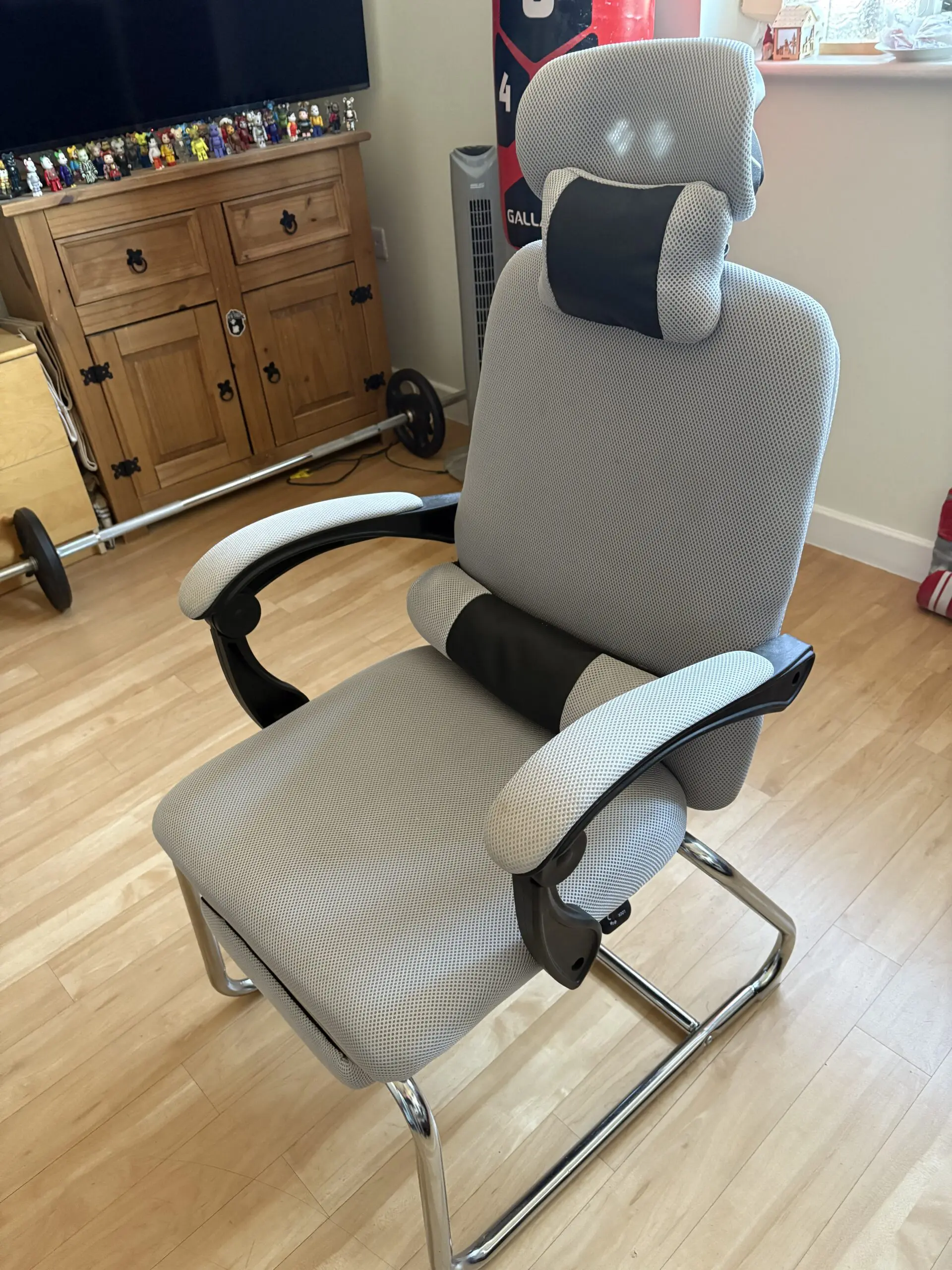 Ergonomic Chair with padded arms and silver metal base with footrest light grey