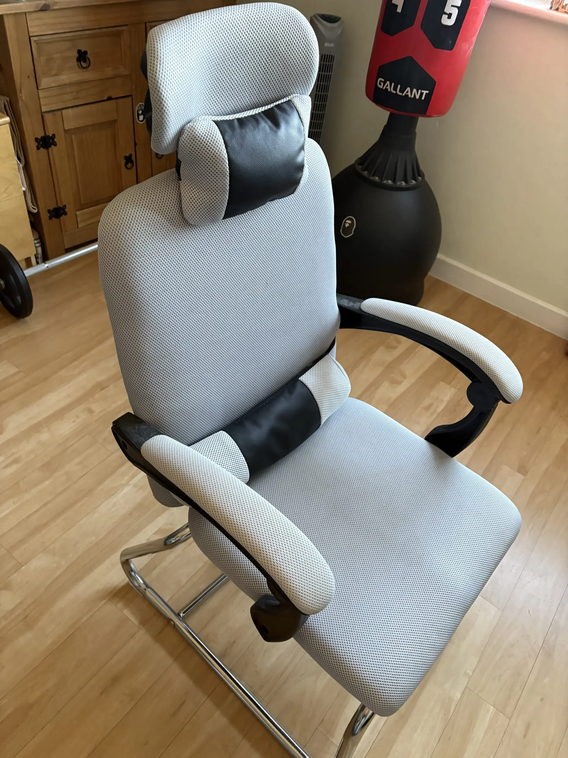 Ergonomic Chair with padded arms and silver metal base with footrest light grey