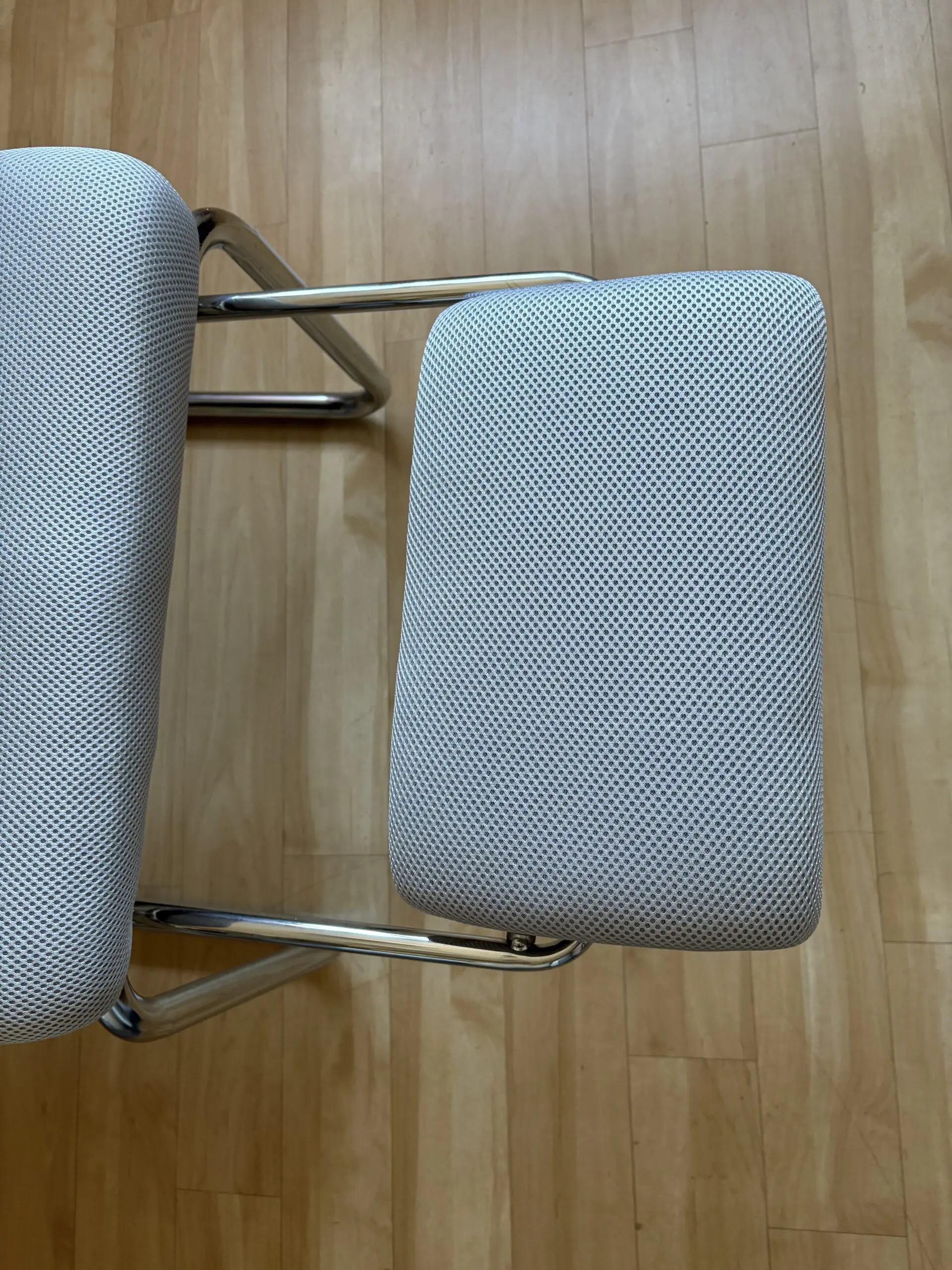 Ergonomic Chair with padded arms and silver metal base with footrest light grey