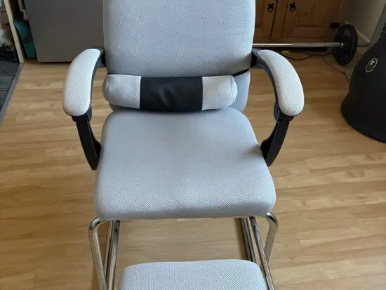 Ergonomic Chair with padded arms and silver metal base with footrest light grey