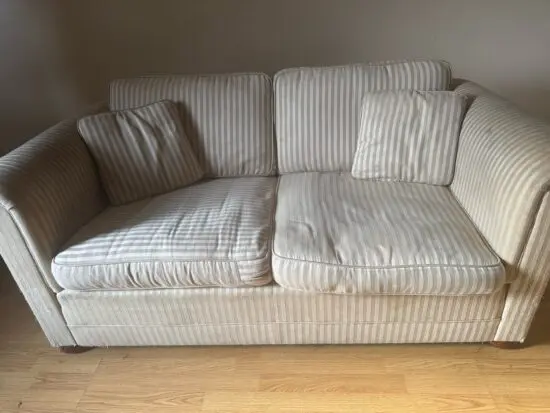 It’s a cream two seater sofa with pillows