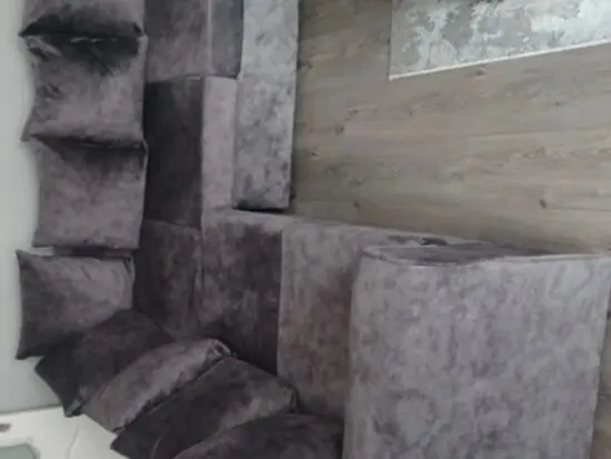 Grey material corner sofa