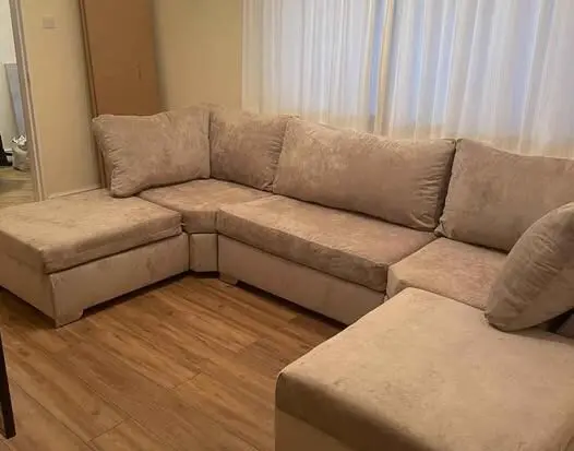 Beige u shape sofa with highback cushions