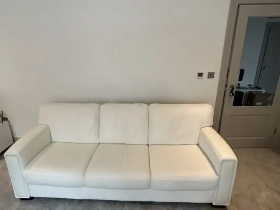 Like new white Italian leather sofas and footstool: pet-free and smoke-free home