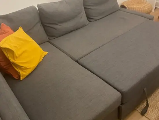 dark grey corner sofa bed, it has storage place under. 2 people can easily sleep when it turns to bed.