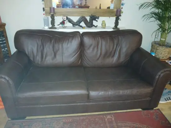 2 x 3 seater brown leather sofas by M&S.