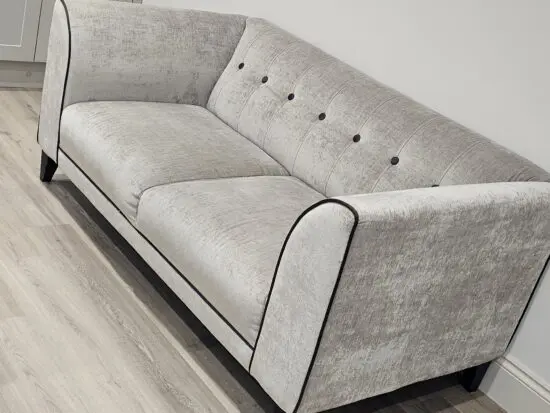 DFS soft grey 2 seater sofa with chocolate piping