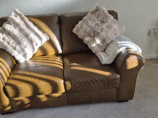 Tan leather 2 seater sofa comes with new leather cleaning kit