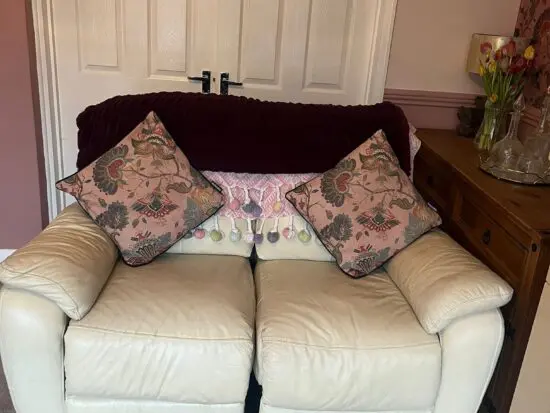 2 seater cream leather reclining sofa in very good condition.