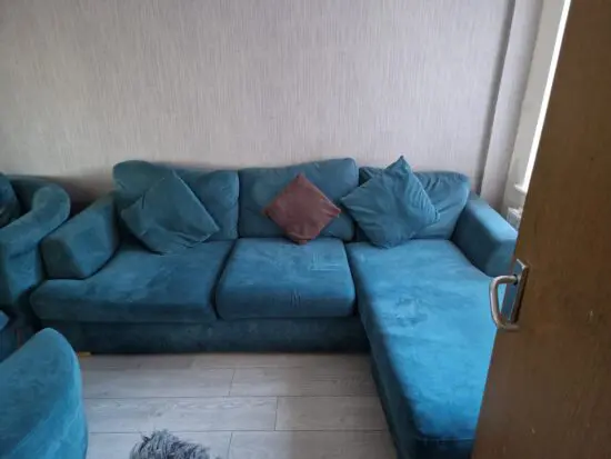 Emerald green corner sofa and round chair