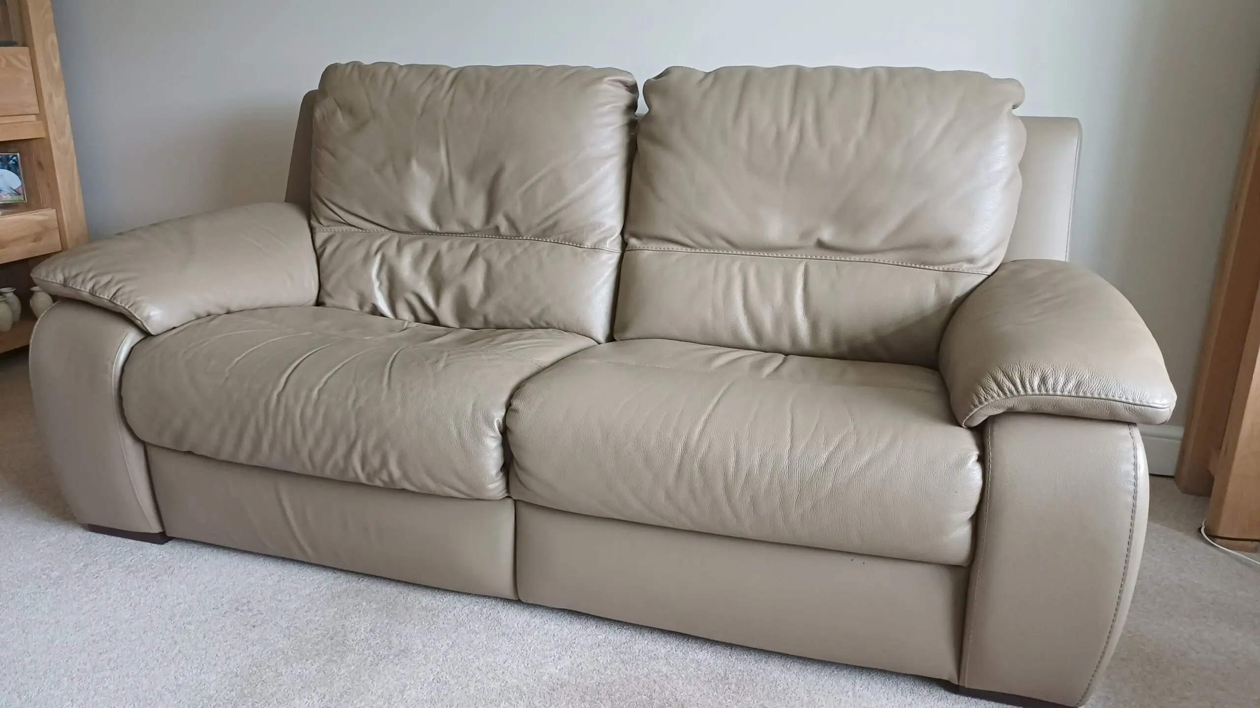Pair of leather Italian styled 2 seater sofas each with electric recliner on one half