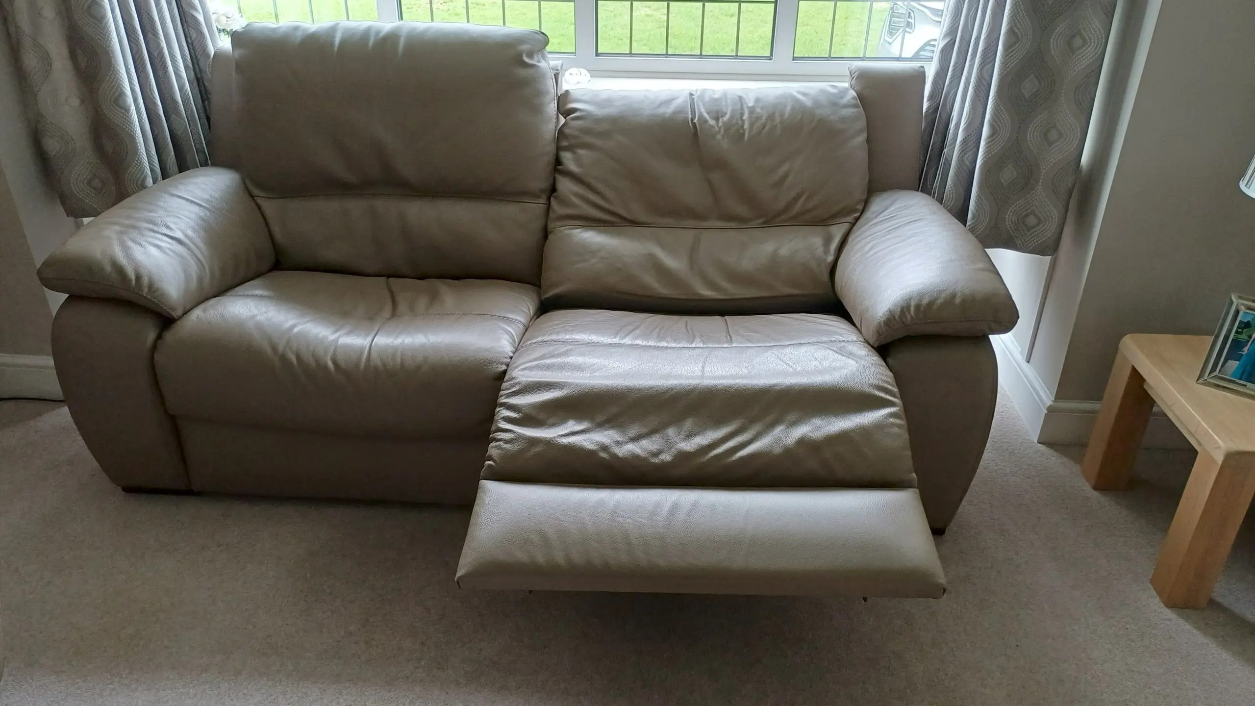 Pair of leather Italian styled 2 seater sofas each with electric recliner on one half