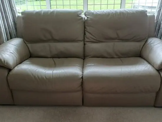 Pair of leather Italian styled 2 seater sofas each with electric recliner on one half