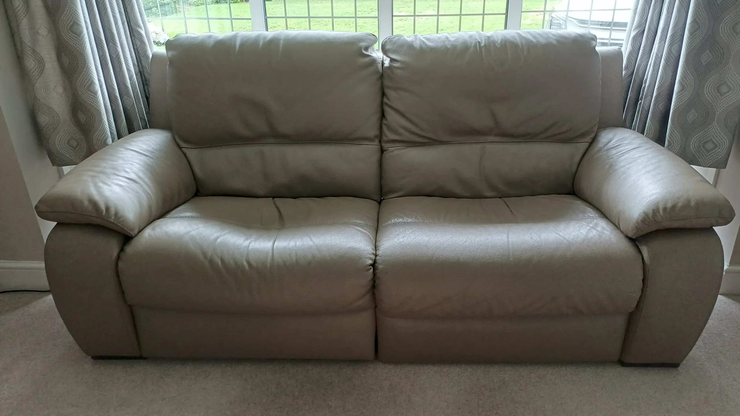 Pair of leather Italian styled 2 seater sofas each with electric recliner on one half