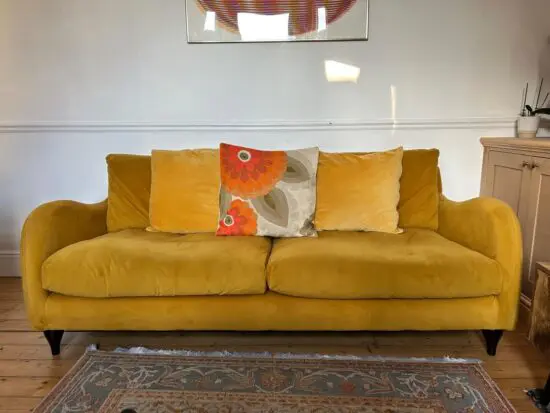MADE Mustard yellow velvet sofa
