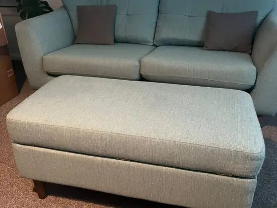 DFS large green 2 seater sofa and storage footstool