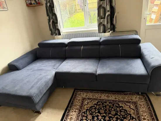 Navy blue corner sofa that converts into a sofa bed