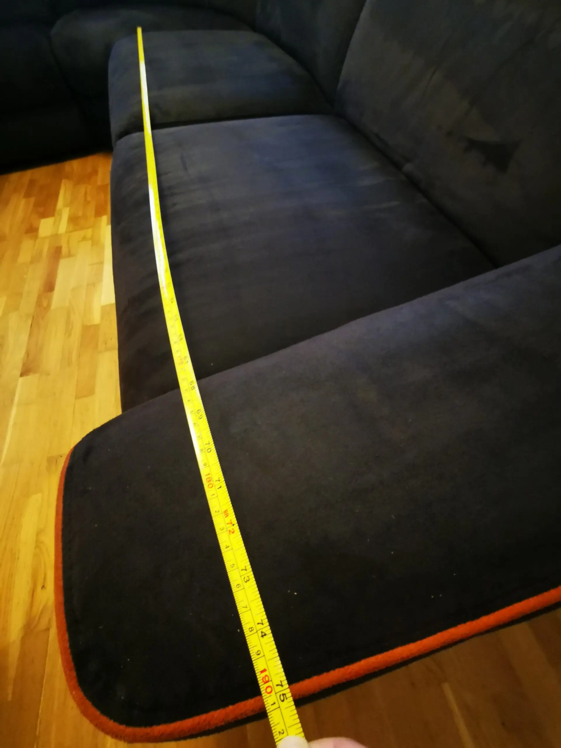 Furniture Village, corner sofa with 3 power recliner seats, black with orange piping