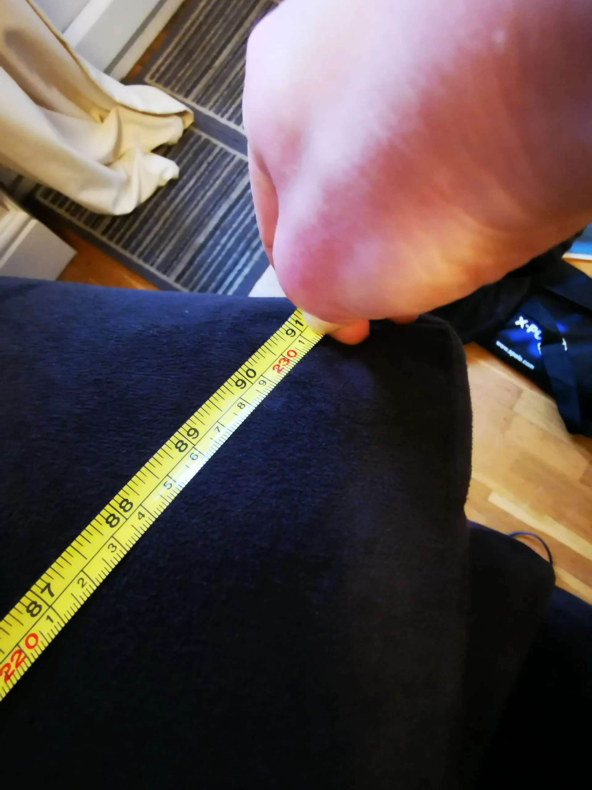 Furniture Village, corner sofa with 3 power recliner seats, black with orange piping