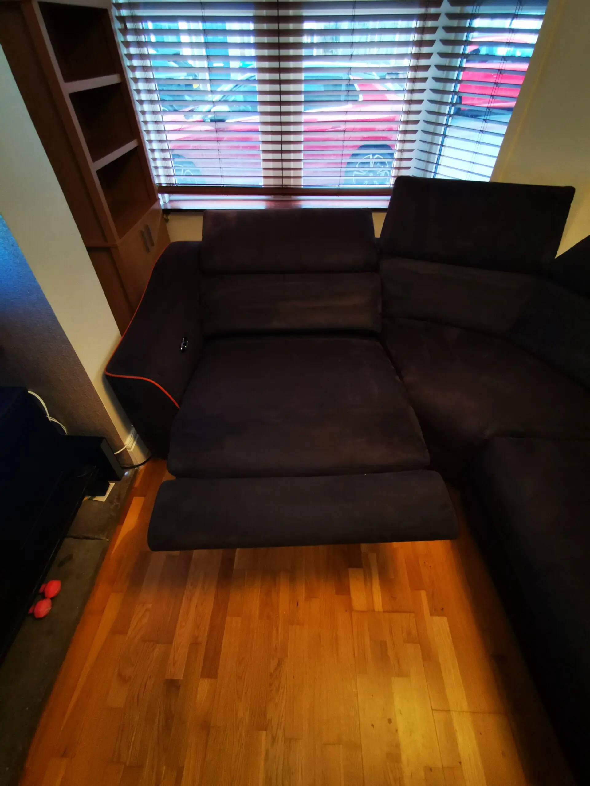 Furniture Village, corner sofa with 3 power recliner seats, black with orange piping