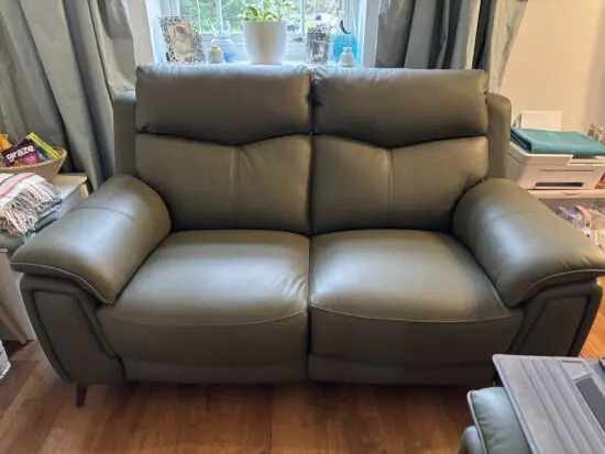 Almost New 2 x 2 Seater Power Recliner Sofas in Olive Green Leather (DFS Stowen)