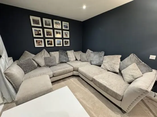 Dark grey DFS corner sofa + footstool