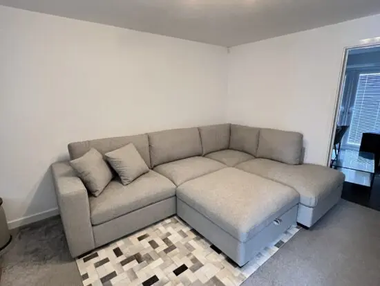 Grey corner sofa, in very good condition. Extremely comfortable, with chaise and ottoman.