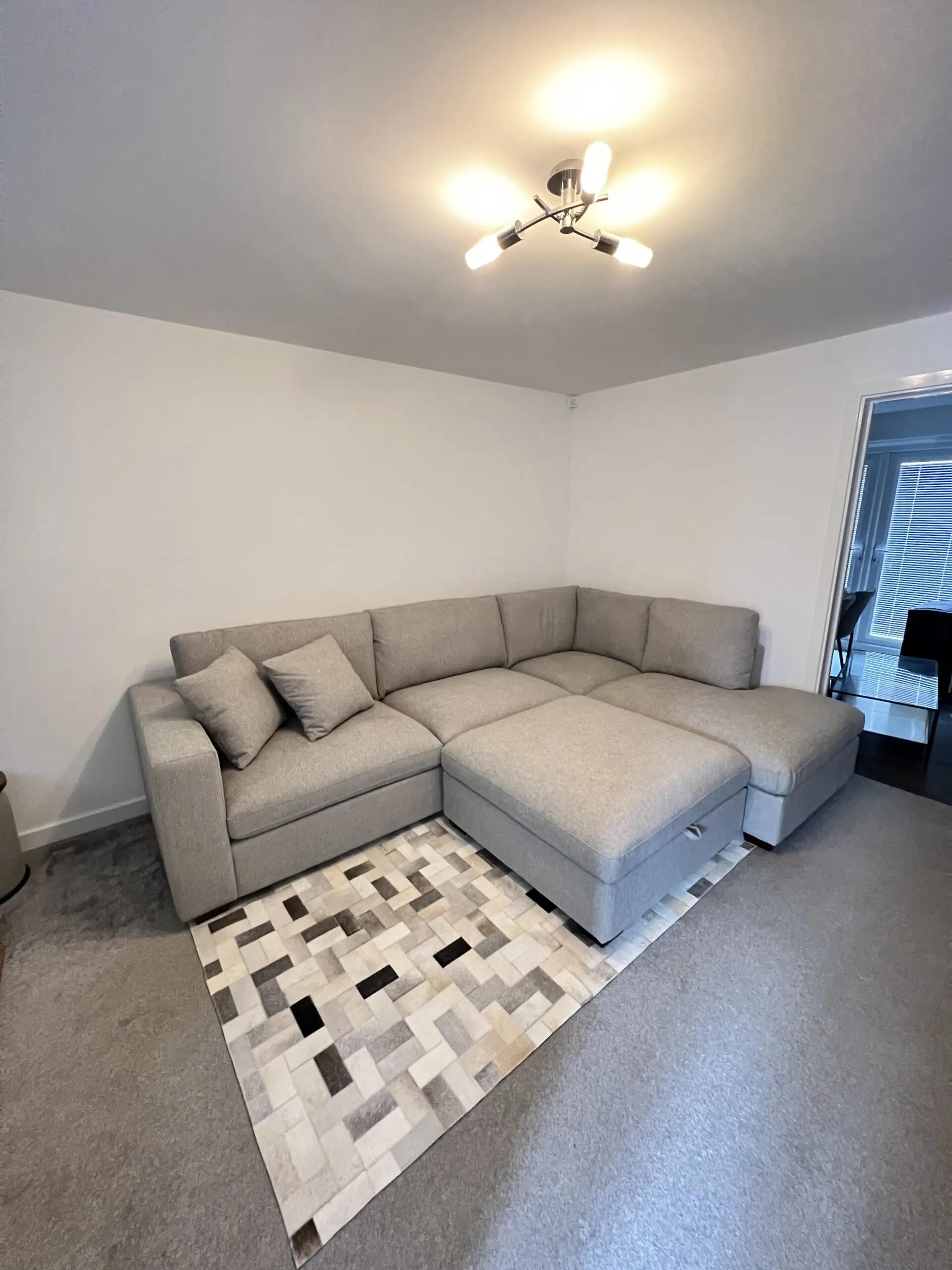 Grey corner sofa, in very good condition. Extremely comfortable, with chaise and ottoman.