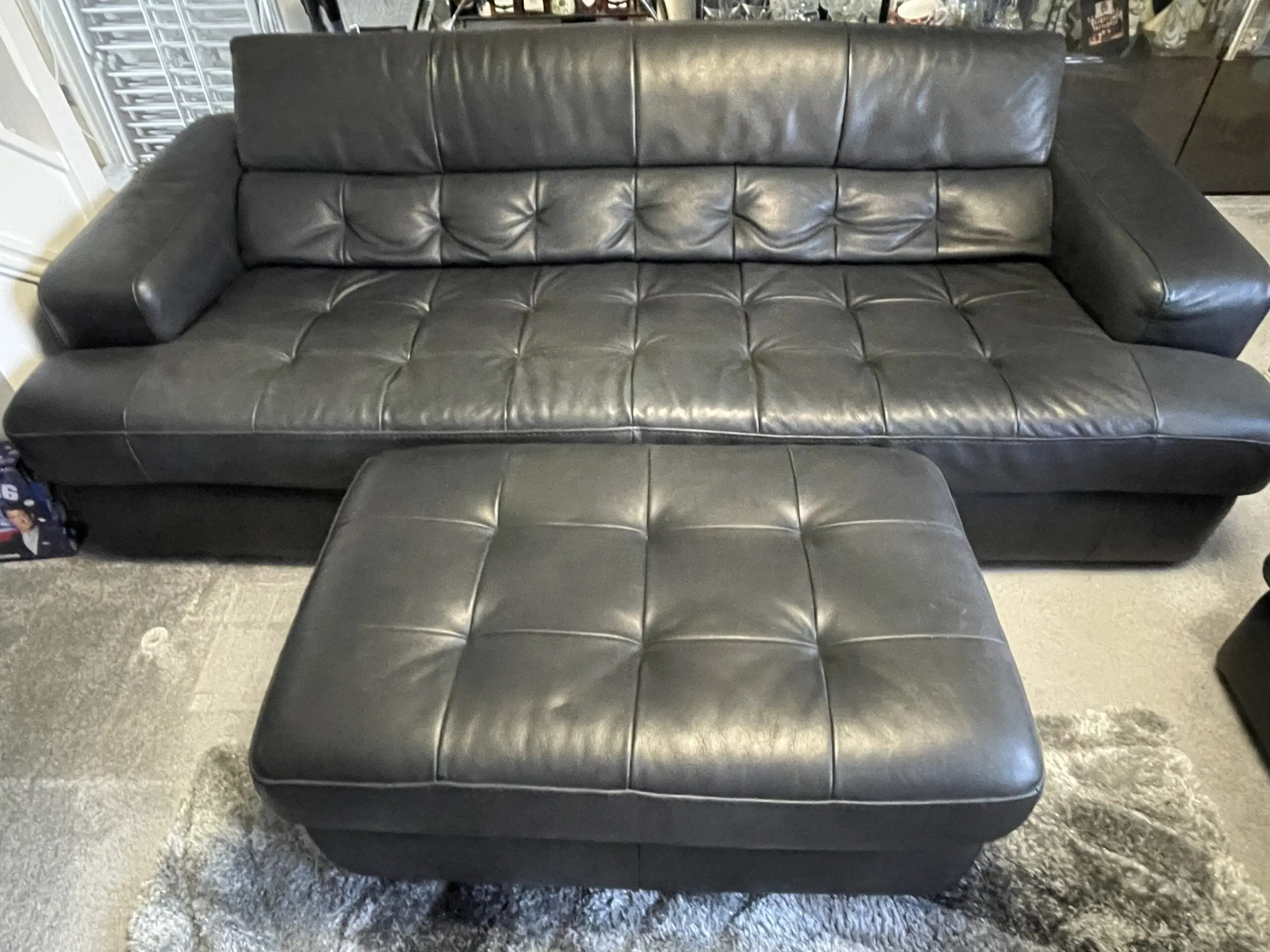 Castelano black Italian full grain leather sofas and footstool.