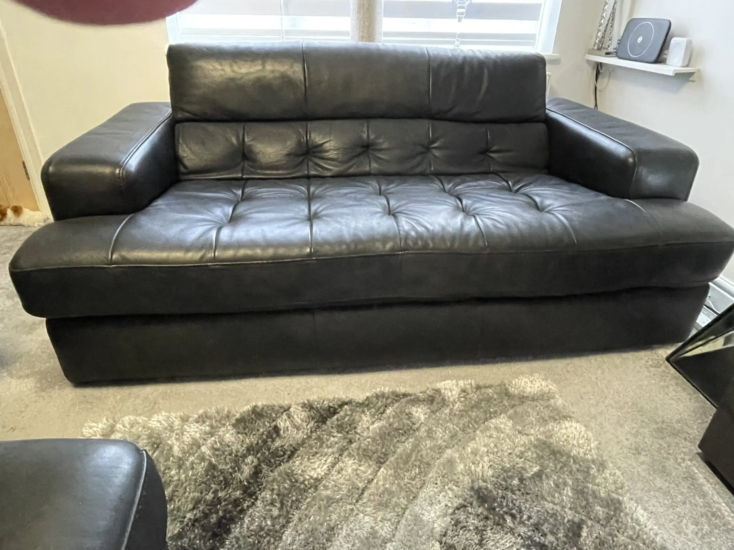 Castelano black Italian full grain leather sofas and footstool.