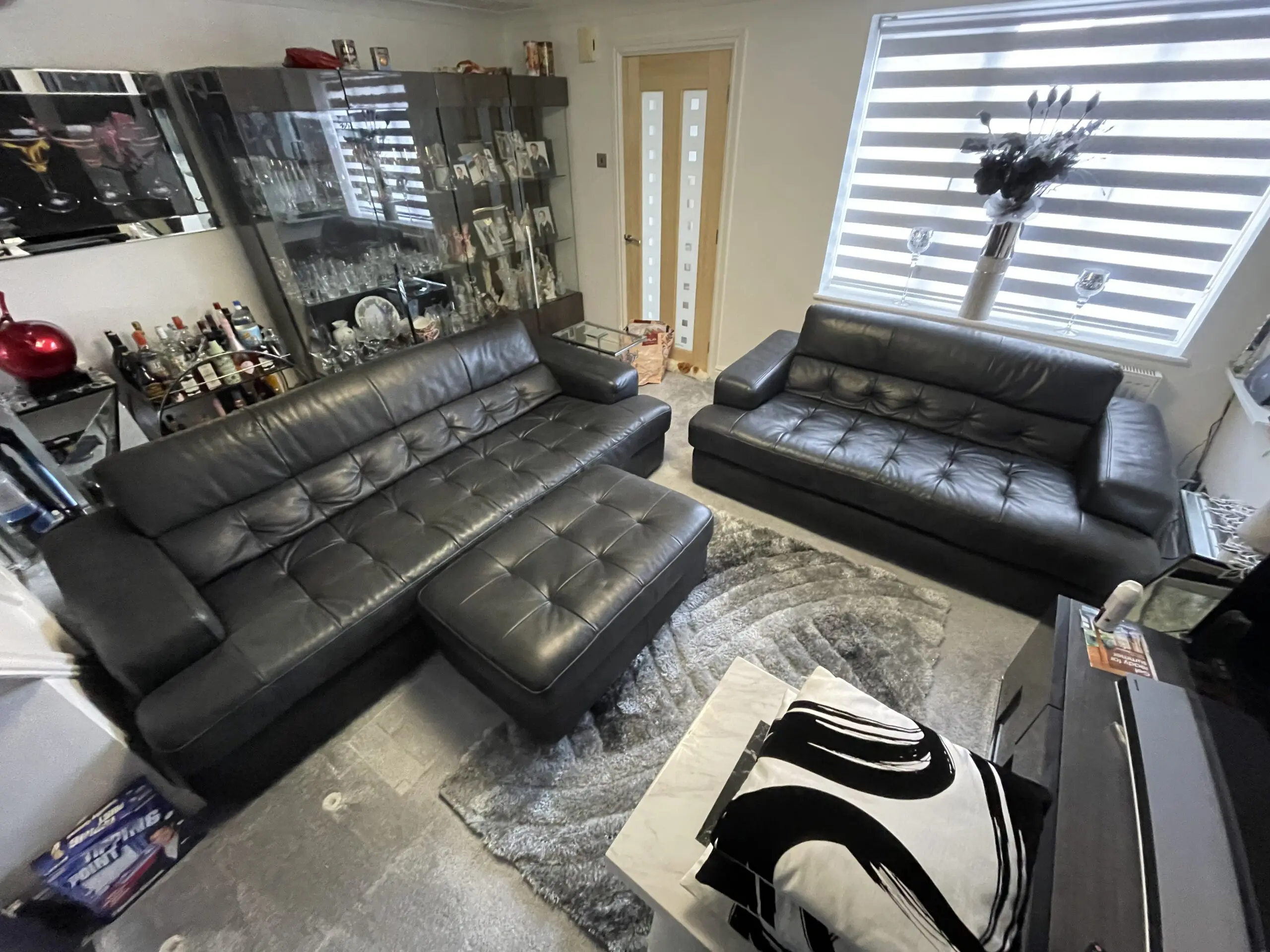 Castelano black Italian full grain leather sofas and footstool.