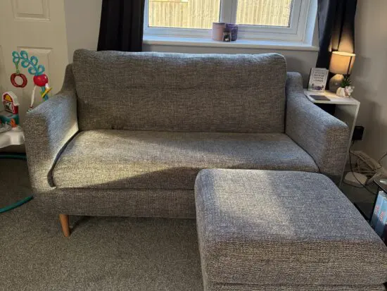 Grey sofa with foot stall
