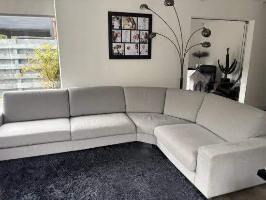 L shape bespoke made grey fabric sofa with hexagonal corner