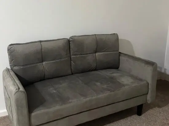 Grey two seater velvet sofa