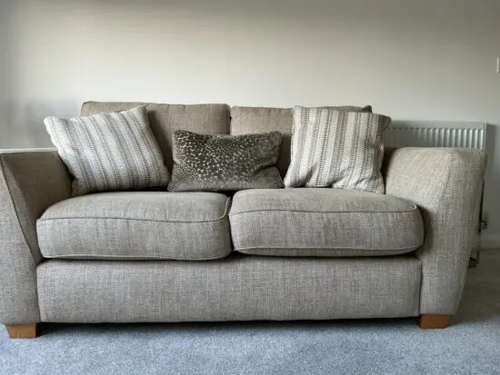 Two beige 2 seater sofas with matching cushions