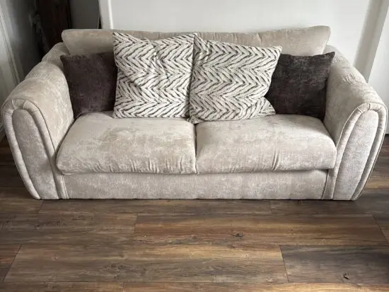 3 and 2 seater beige sofas with foot stool.