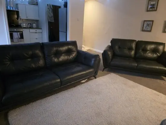Dark green leather 4 seater and 2 seater dfs sofas