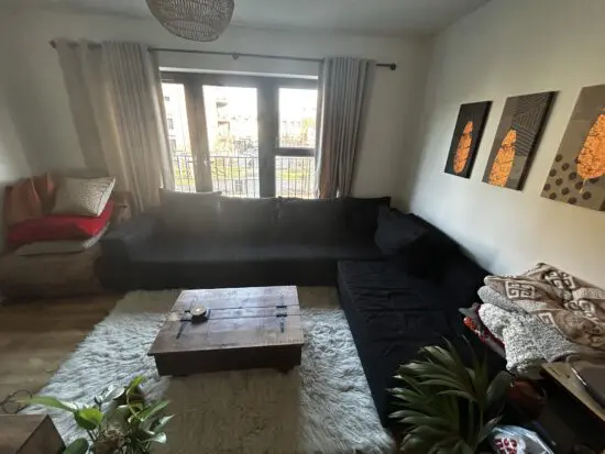 Large, comfortable black fabric corner sofa available due to replacement.