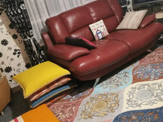 DFS red leather 2 seater sofa