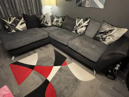 Sofology black and grey L shaped sofa and swivel cuddle seat.
