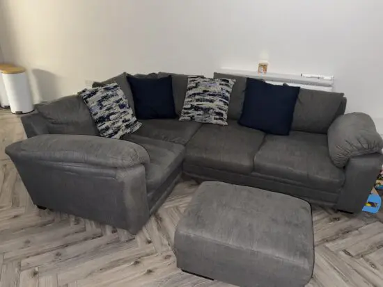 Grey corner sofa with footrest