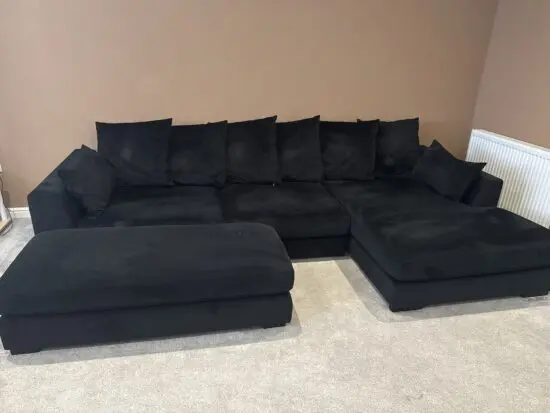 Dfs black velvet corner sofa with large foot stool