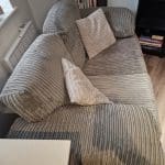 Grey 2 Seater Sofa with 2 pillows and Unused Fabric Care Kit