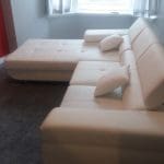 White leather corner sofa bed