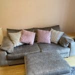 Large grey sofa with ottoman footstool