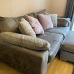 Large grey sofa with ottoman footstool