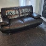 Black sofa and armchair with foot rest