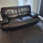 Black sofa and armchair with foot rest