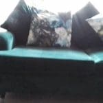 Large three seater forest green velvet sofa
